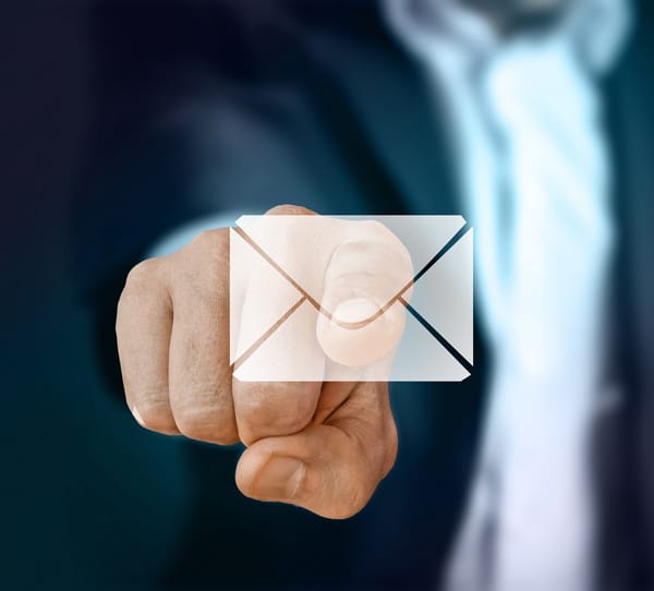 A floating, transparent email icon and someone poking it as if to open the email.
