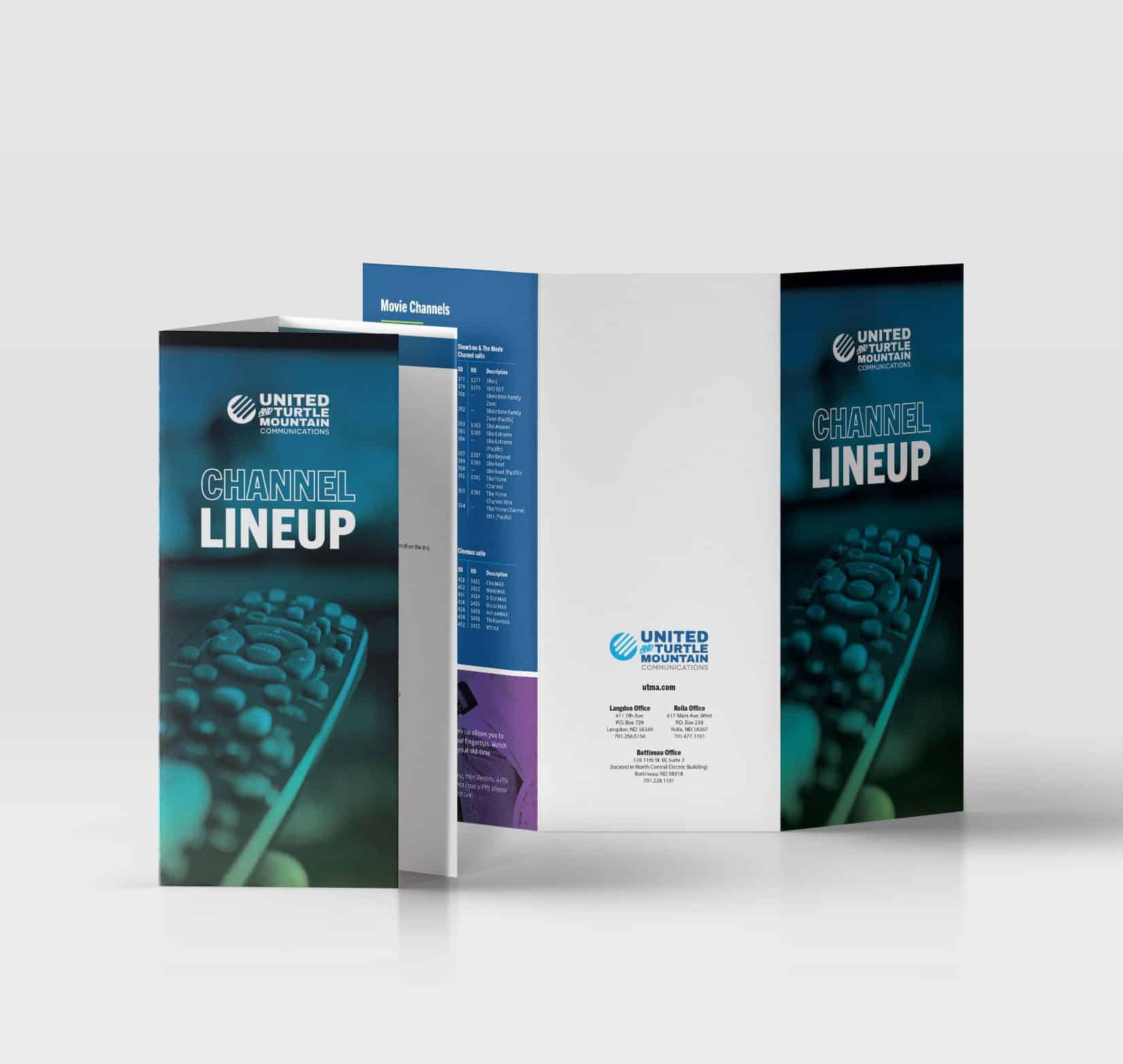 Two copies of a color printed tri-fold channel lineup guide for United Communications propped up on a white background