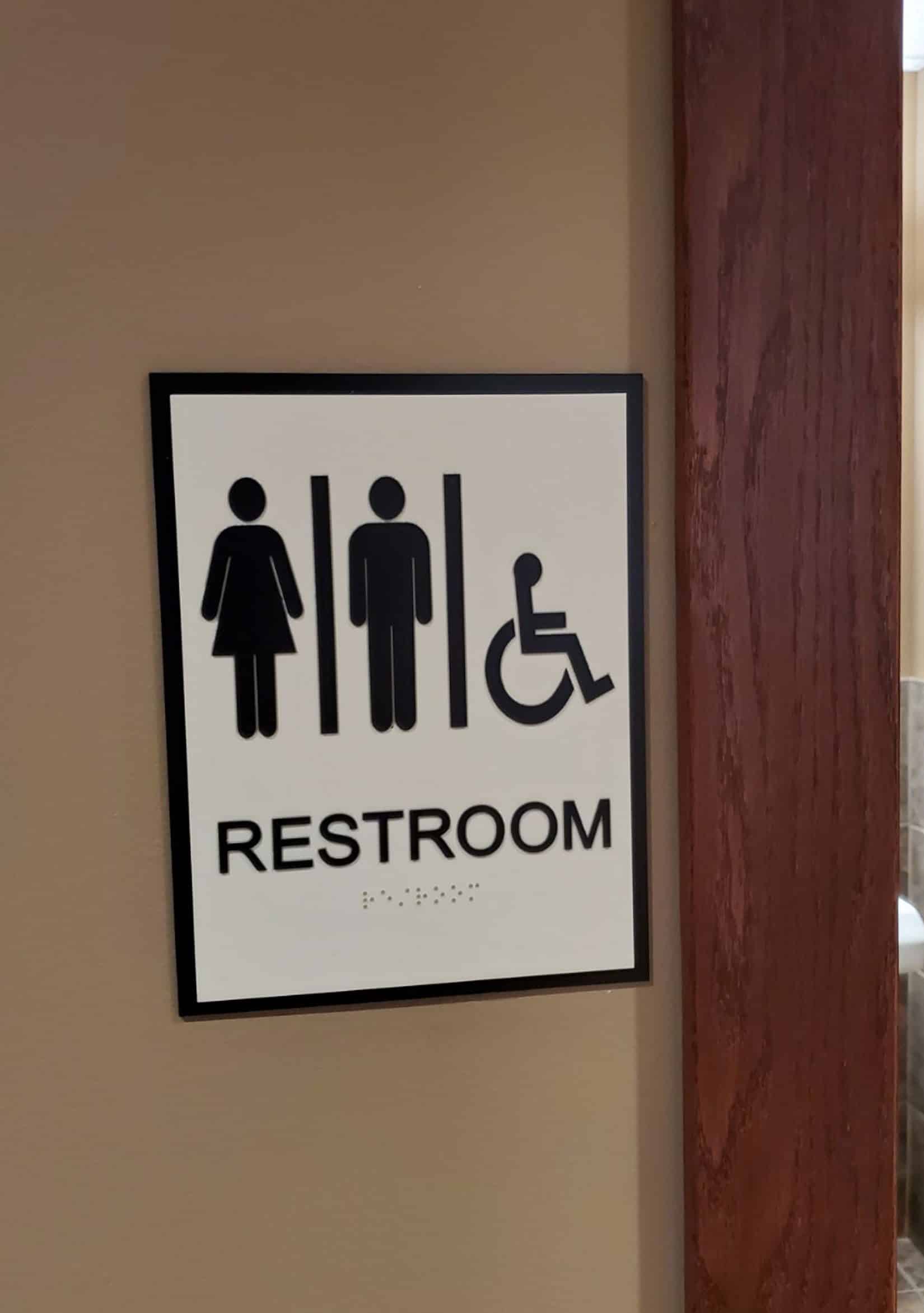 Restroom sign installed in commercial building.