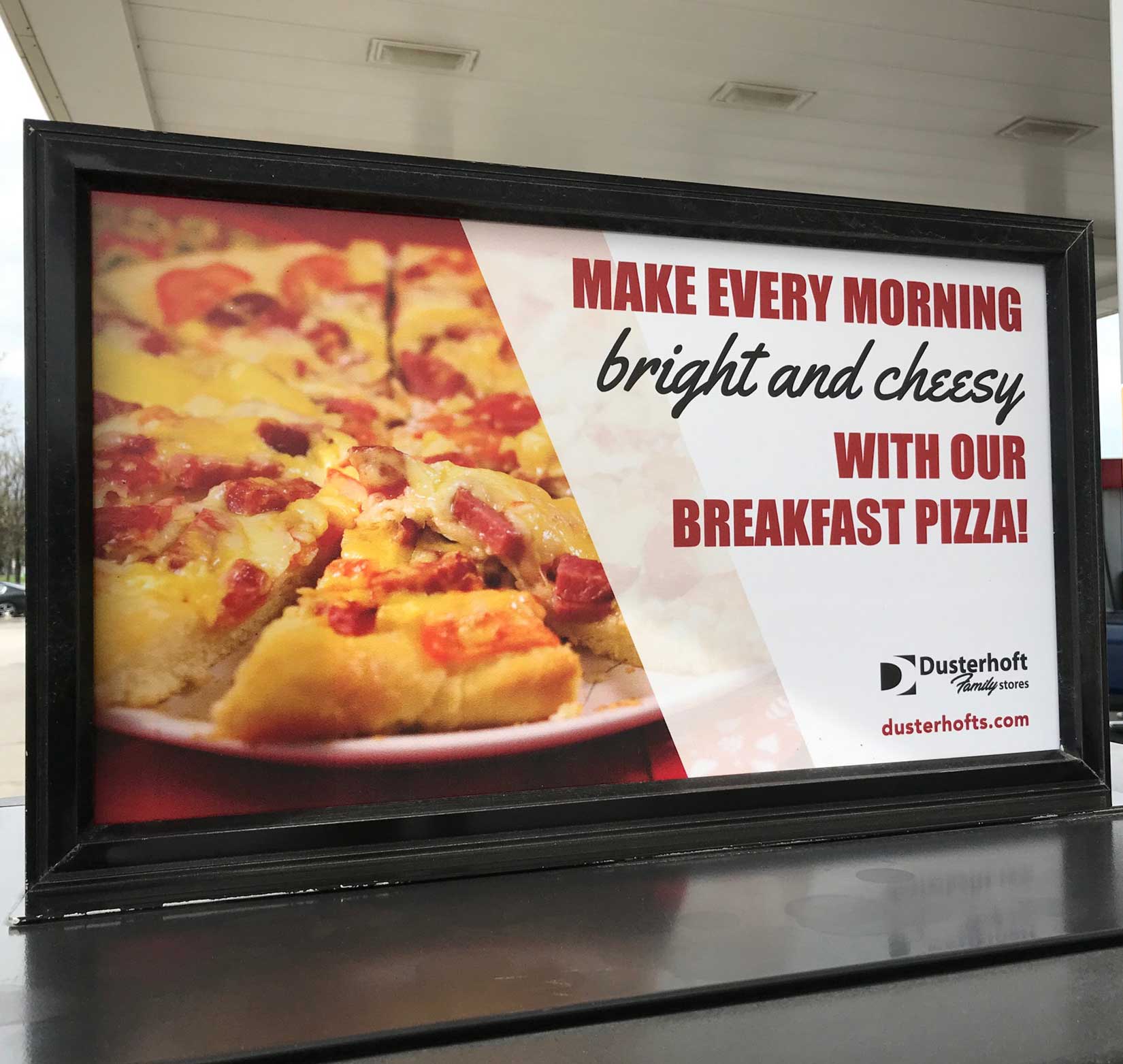 A printed poster advertising breakfast pizza at Dusterhoft Family Stores