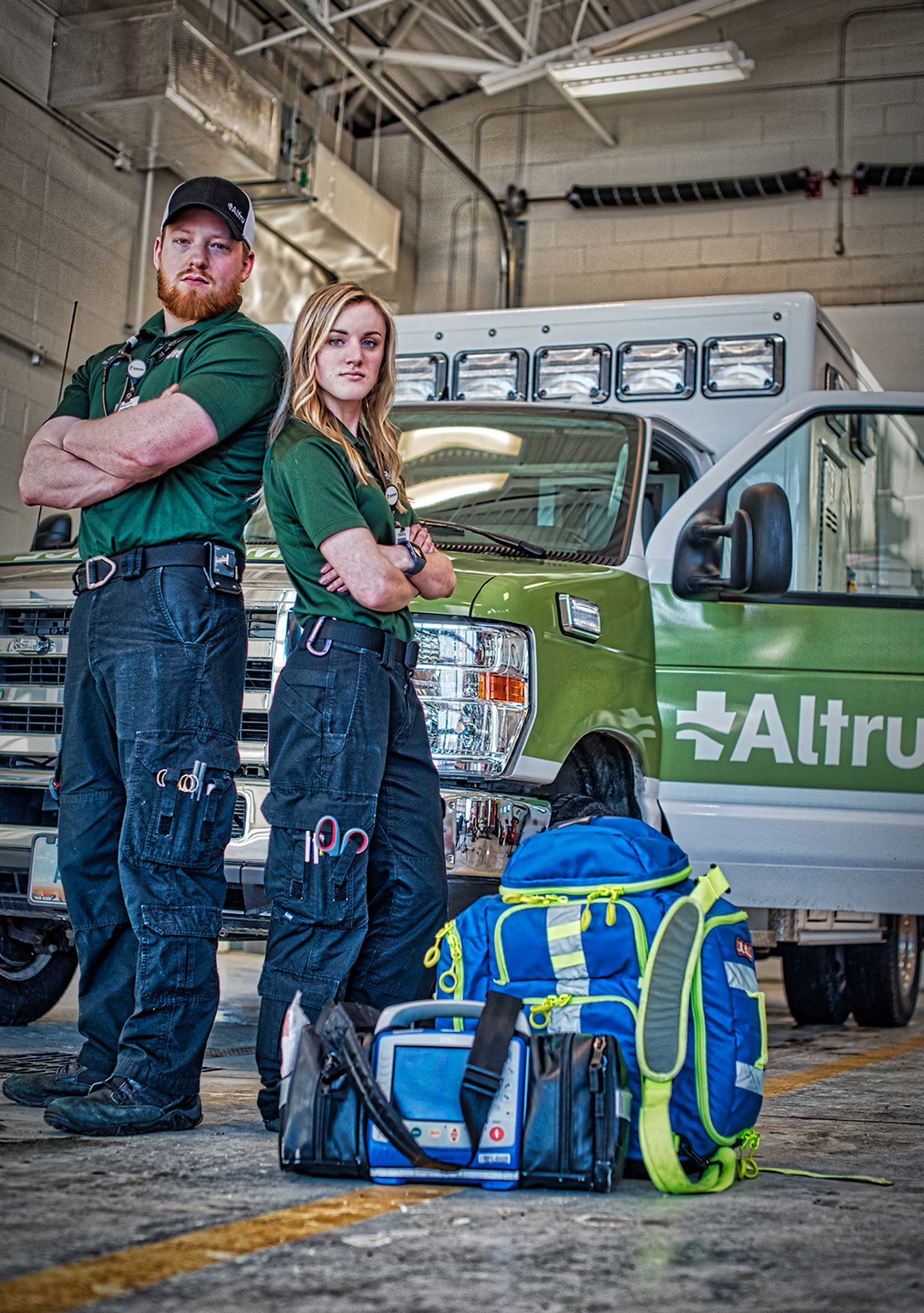 Professional photograph of two first responders for Altru posing in front of an ambulance