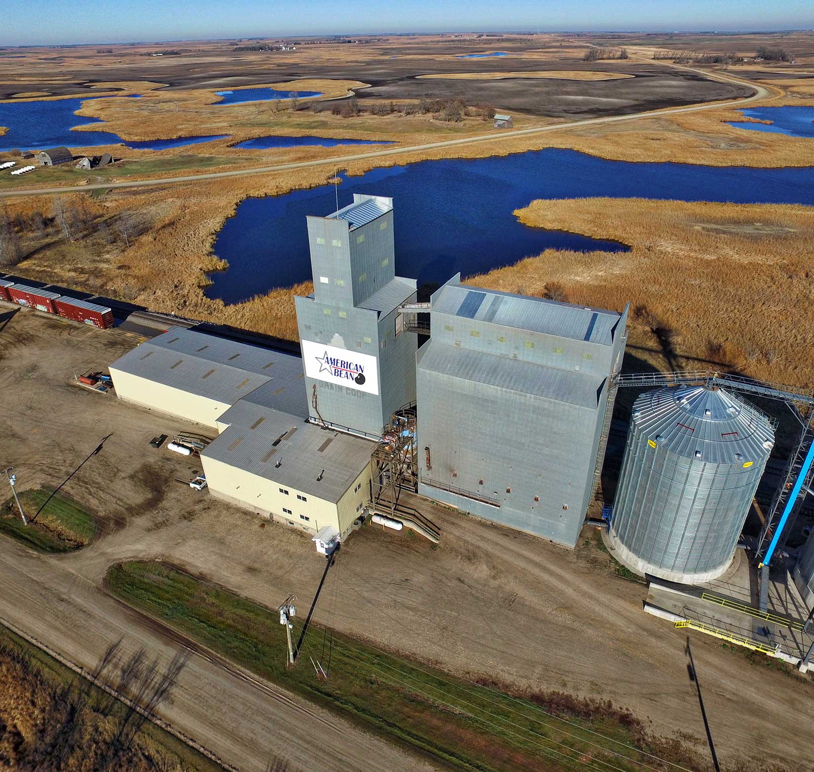 A professional aerial photo of a grain elevator in a rural location