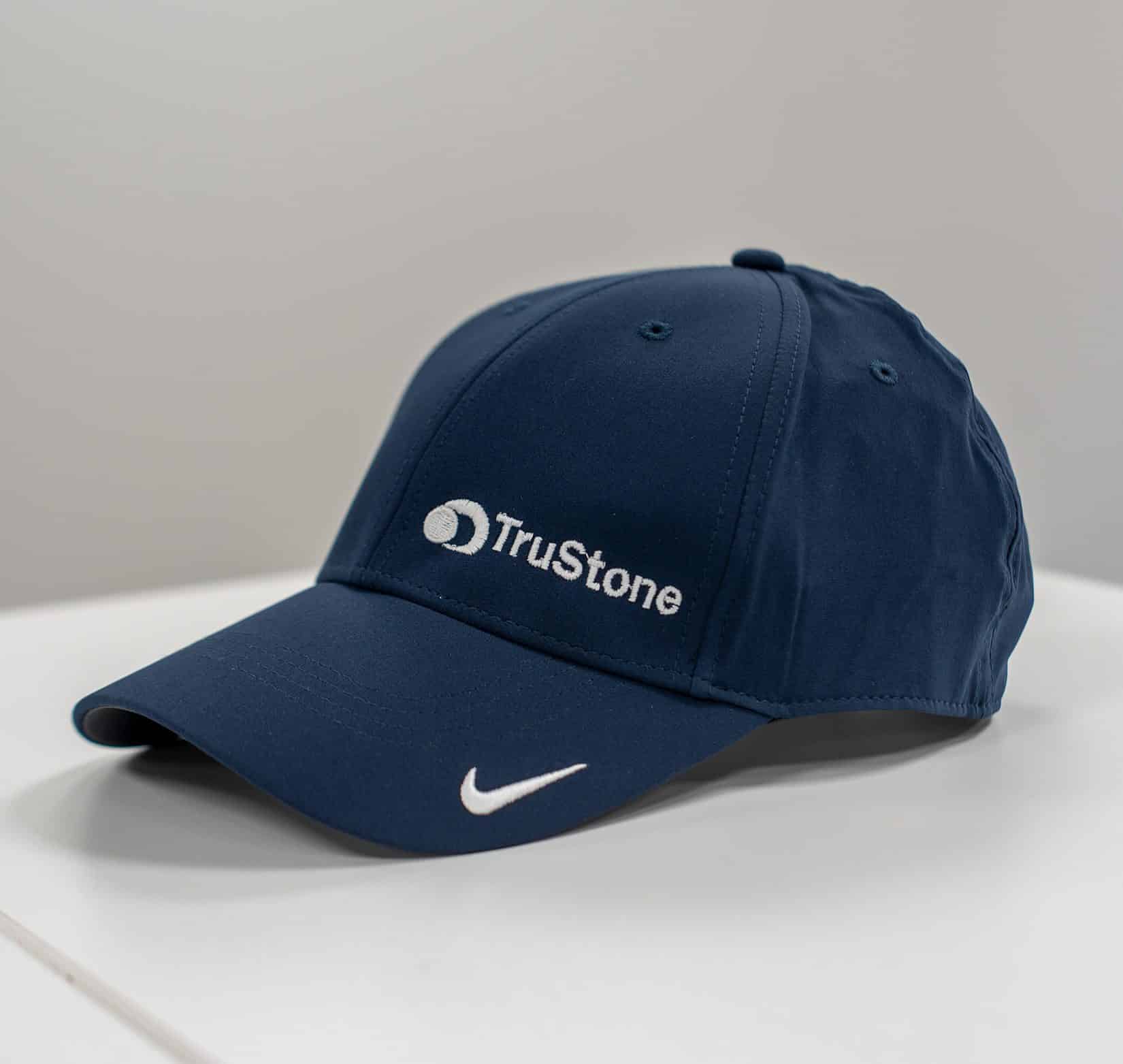 A navy blue baseball cap that has TruStone logo embroidered on it.