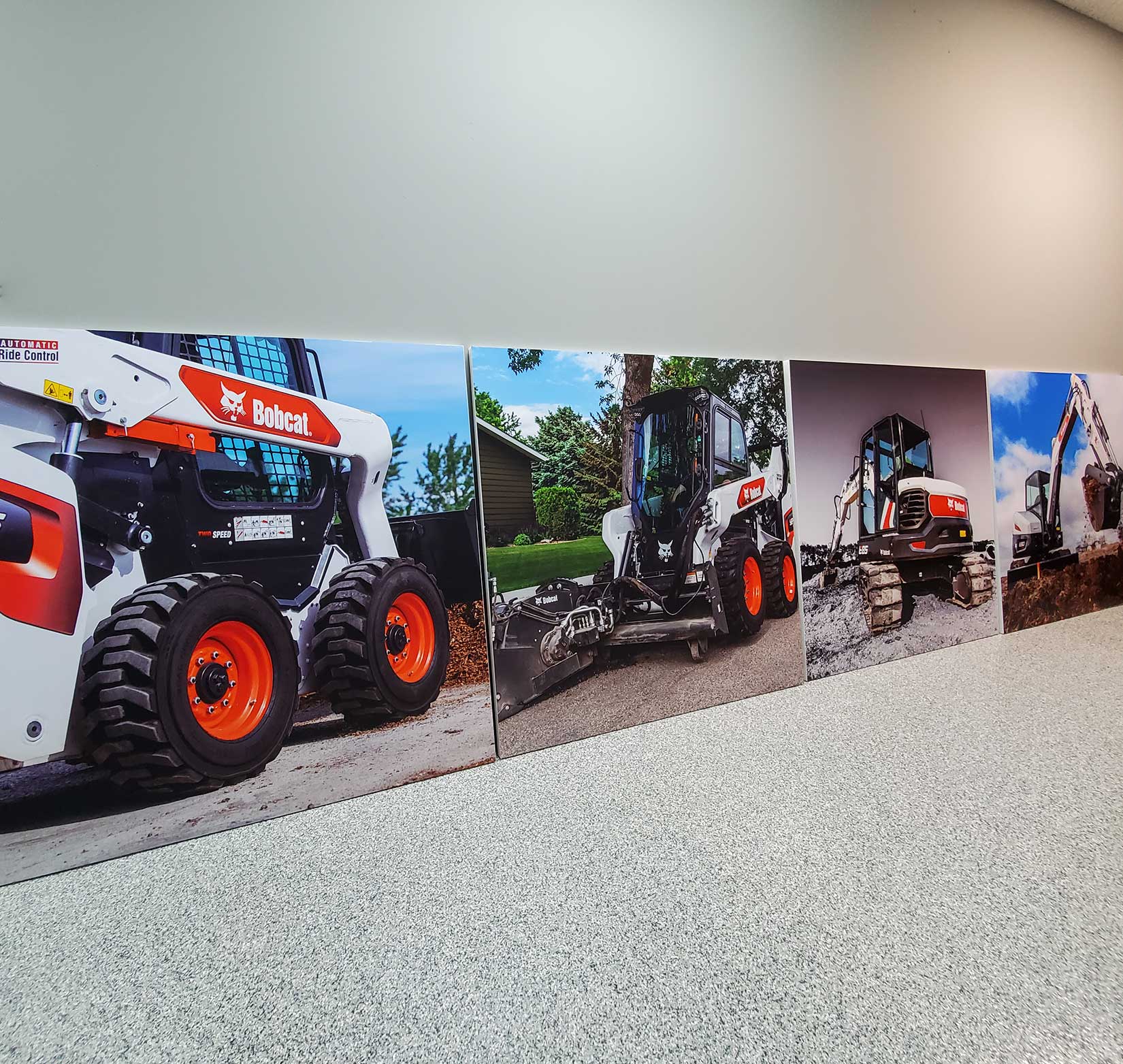 Photo of a series of canvases that show tractors.
