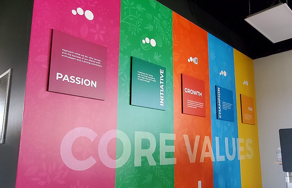 A colorful wall mural inside Stray Media Group to display its core values