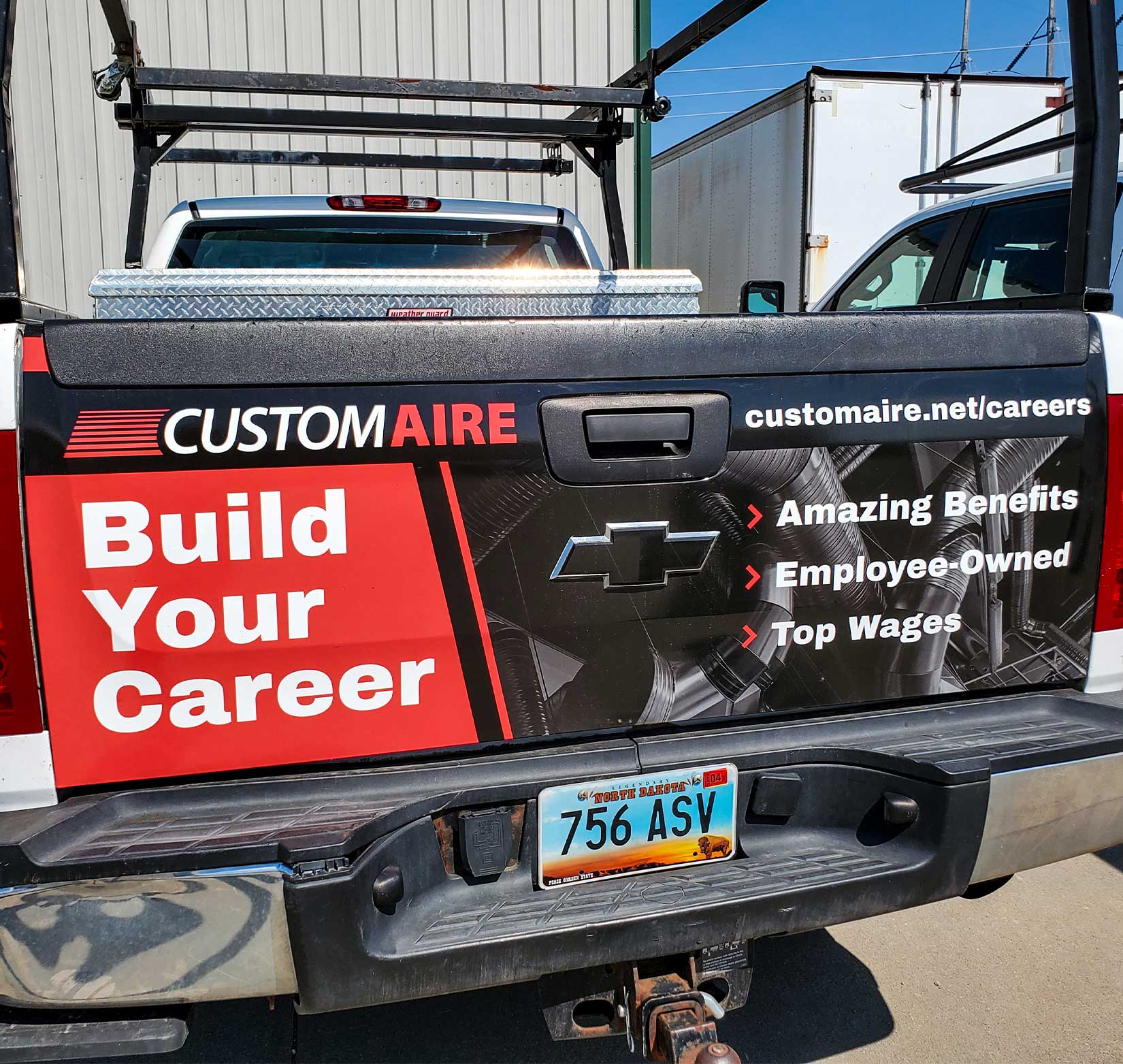 A vinyl wrap on the tailgate of a Custom Aire fleet truck.