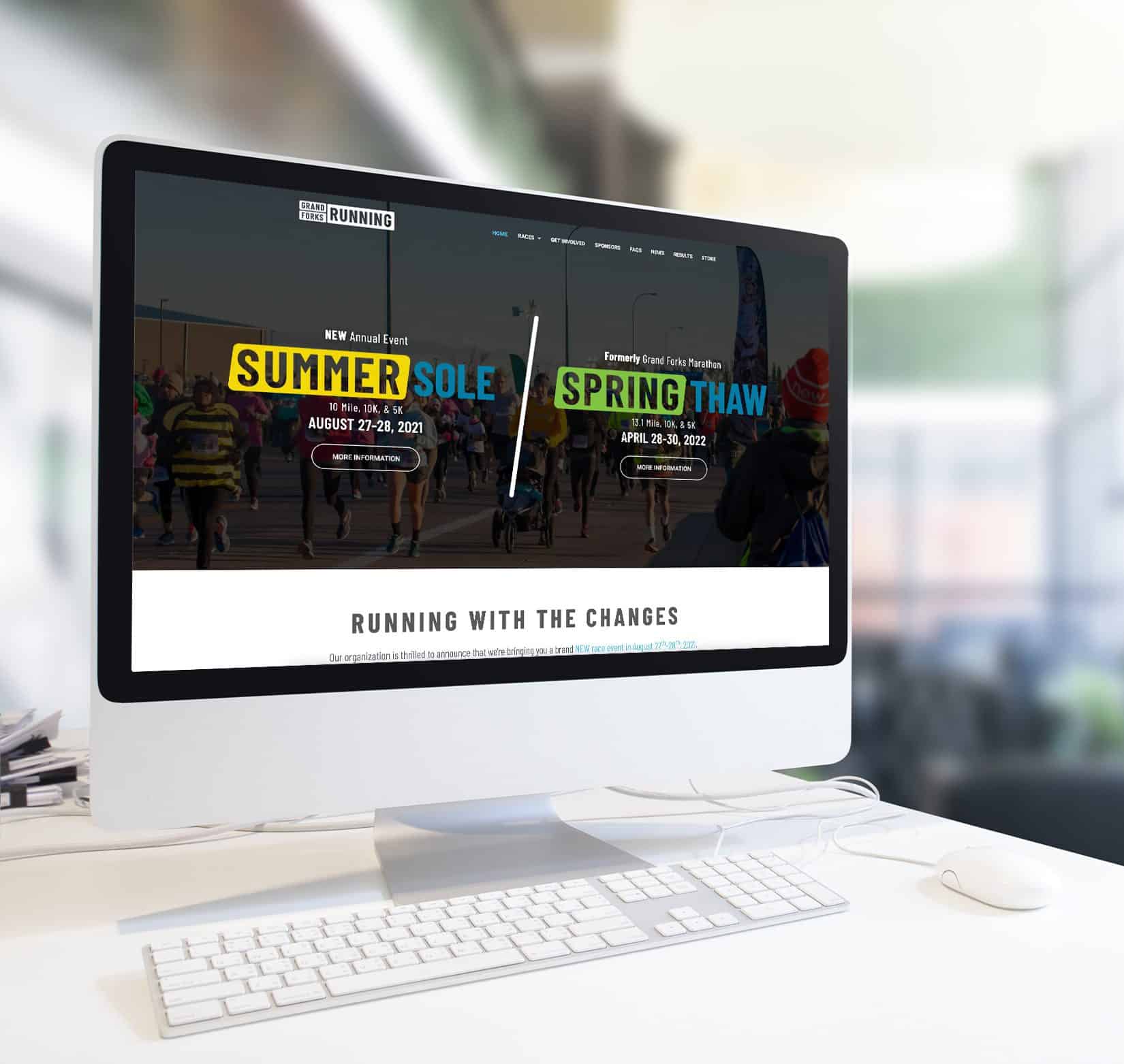 A website designed for Grand Forks Marathon shown on the screen of a desktop computer.